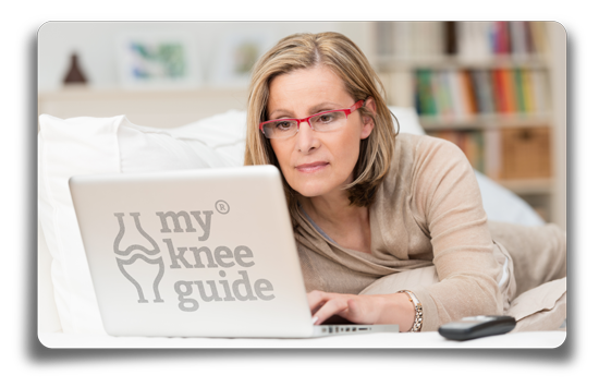 Woman working while lying with laptop computer